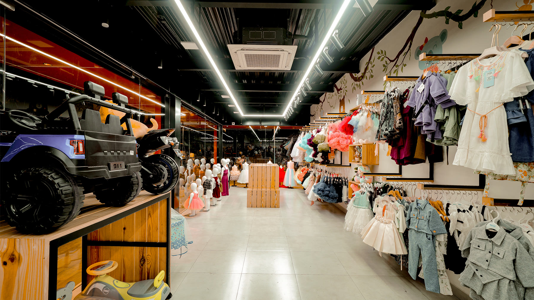 Amie's Studios retail interior with black framework and colourful clothing
