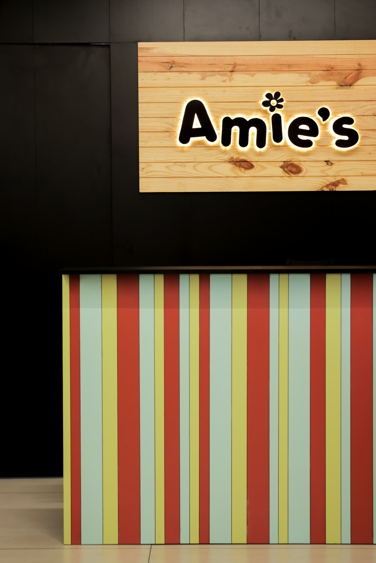 Amie's Studios entrance signage with vertical colour bars