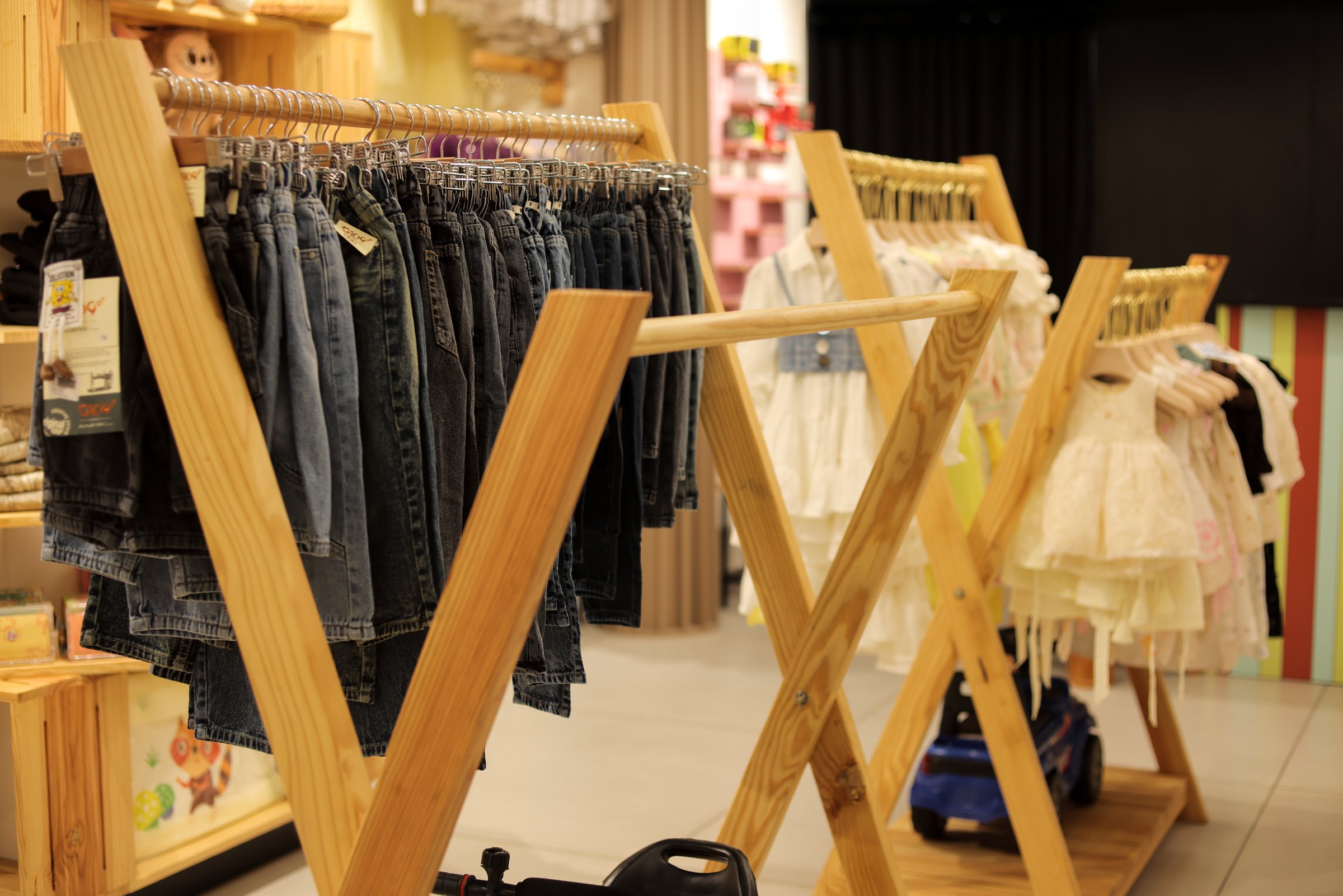 Custom pinewood clothing rack and children's display at Amie's Studios