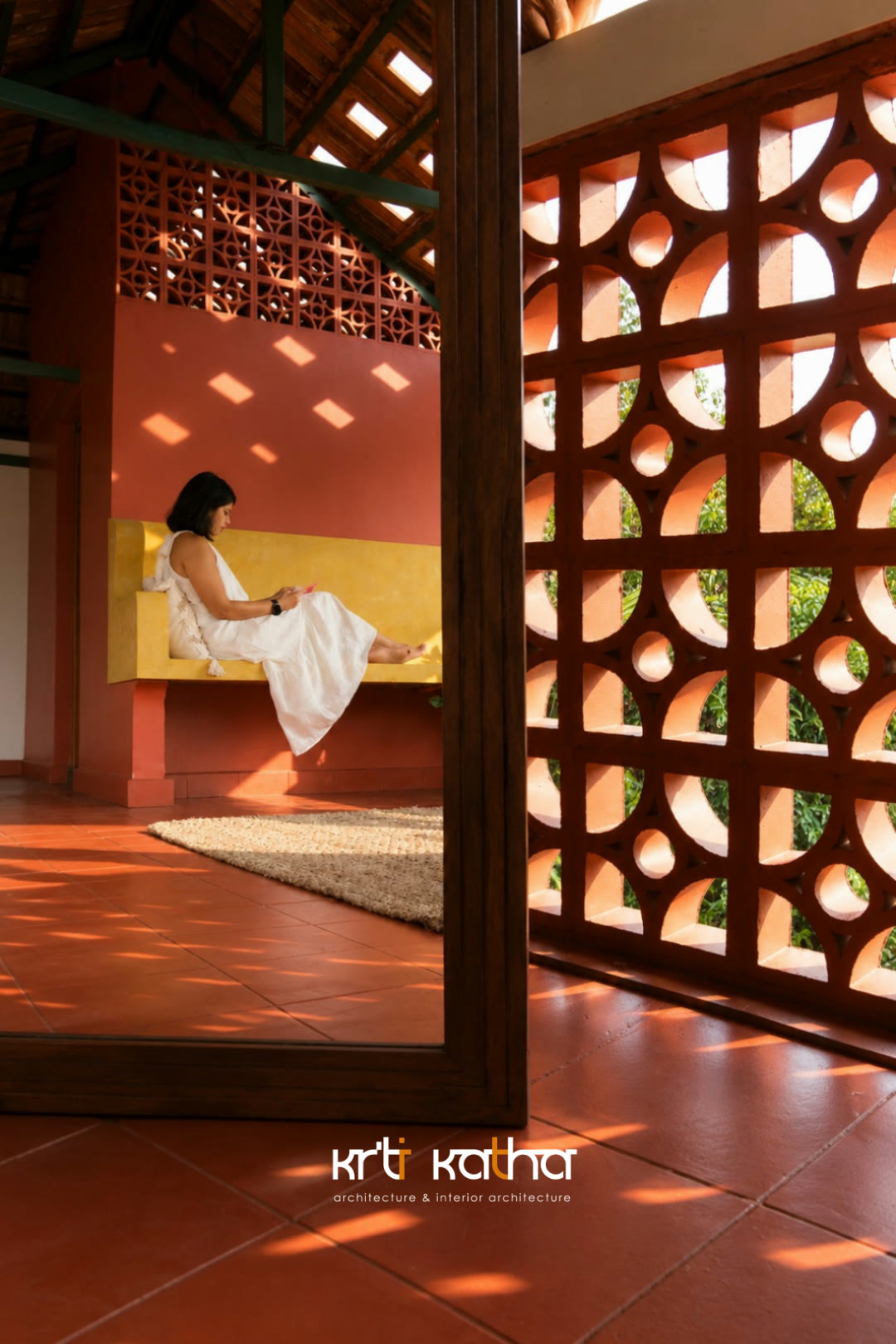 Sunlight casting a terracotta jaali pattern across an oxide floor