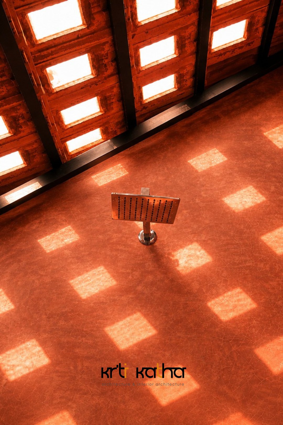 Terracotta jaali casting patterned sunlight across the red oxide floor at Edam Residence