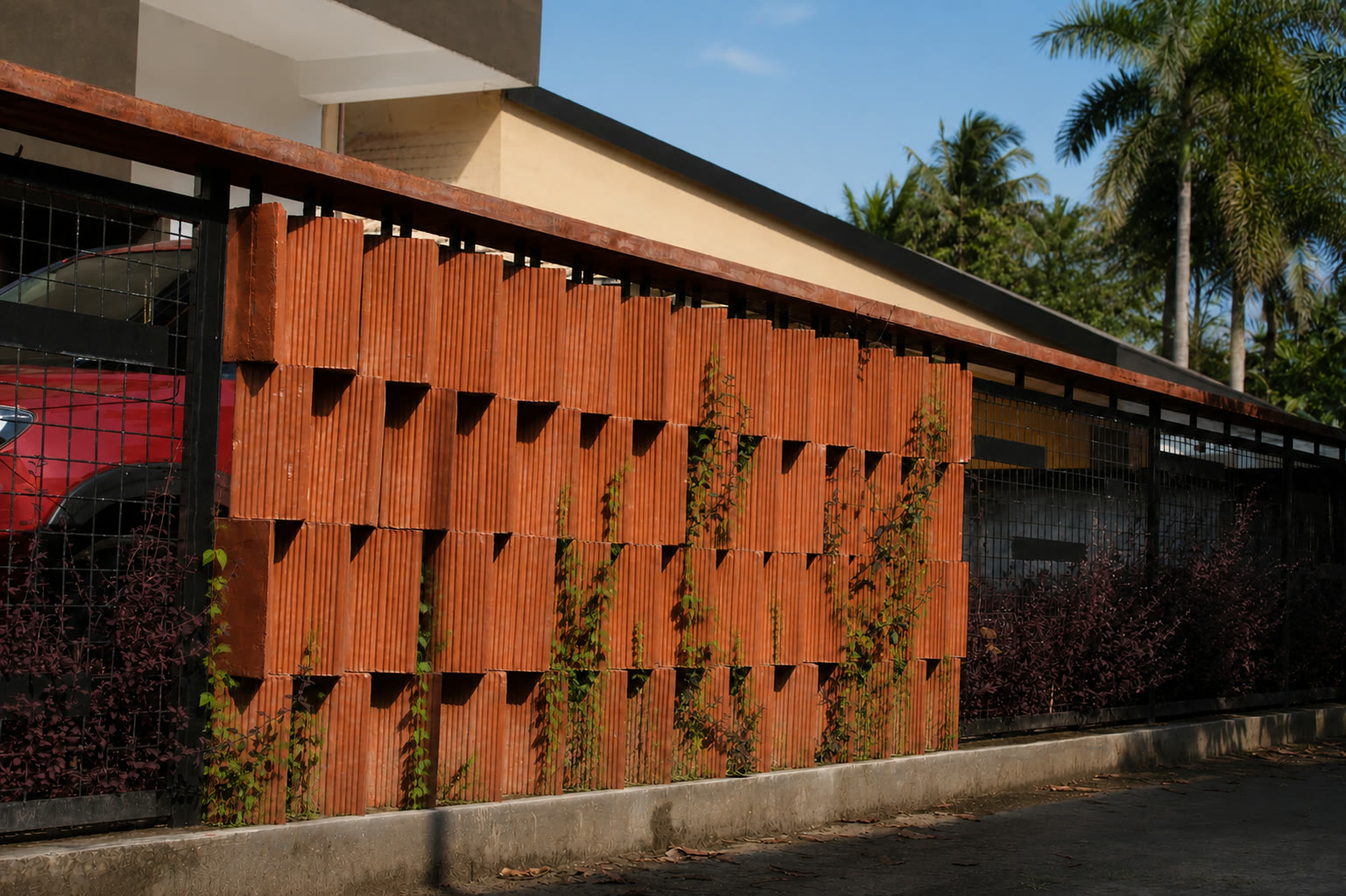 Ivy Villa boundary wall built with a rhythmic terracotta brick bond